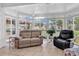 Sunroom featuring tile floors, comfortable seating, and an abundance of natural light through large windows at 1619 Deer Park Ln., Surfside Beach, SC 29575