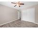 Bedroom featuring neutral paint, wood-look floors, ceiling fan, and closet at 178 Beaver Pond Loop # 60, Pawleys Island, SC 29585