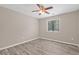 Bedroom with wood-look flooring, neutral walls, and a window providing views and natural light at 178 Beaver Pond Loop # 60, Pawleys Island, SC 29585