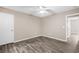 Comfortable bedroom includes neutral walls, wood-look flooring, a ceiling fan, and an inviting doorway at 178 Beaver Pond Loop # 60, Pawleys Island, SC 29585