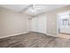 This bedroom has wood-look floors, a ceiling fan, and access to the ensuite bathroom and closet at 178 Beaver Pond Loop # 60, Pawleys Island, SC 29585