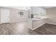 Modern kitchen with a breakfast bar, stainless steel appliances, and natural light with a door to the outside at 178 Beaver Pond Loop # 60, Pawleys Island, SC 29585