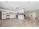 Open concept kitchen with sleek stainless steel appliances, white cabinets, and bright natural light at 178 Beaver Pond Loop # 60, Pawleys Island, SC 29585