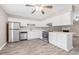 Modern kitchen featuring stainless steel appliances, white cabinets, and a peninsula open to the living area at 178 Beaver Pond Loop # 60, Pawleys Island, SC 29585