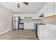 Bright kitchen with stainless steel appliances, white cabinetry and ample counter space with wood-look flooring at 178 Beaver Pond Loop # 60, Pawleys Island, SC 29585