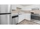 Well-equipped kitchen with stainless steel appliances, white cabinetry, and adjacent dining area at 178 Beaver Pond Loop # 60, Pawleys Island, SC 29585