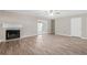 Cozy living room features a fireplace, wood-look flooring, and glass sliding doors to the outside at 178 Beaver Pond Loop # 60, Pawleys Island, SC 29585
