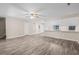 Open living room boasts wood-look flooring, a ceiling fan, and easy access to the kitchen and other living areas at 178 Beaver Pond Loop # 60, Pawleys Island, SC 29585