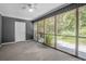 Enclosed sun room featuring ceiling fan and views of the yard at 178 Beaver Pond Loop # 60, Pawleys Island, SC 29585