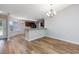 Open dining area with wood floors, modern lighting, and a view into the kitchen at 219 Blackpepper Loop, Little River, SC 29566