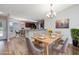 Bright dining area with a wooden table set for six and an open view of the kitchen at 219 Blackpepper Loop, Little River, SC 29566