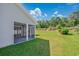 Exterior of the home showcasing the screened-in porch and the spacious, well-maintained backyard at 219 Blackpepper Loop, Little River, SC 29566
