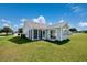 The back of the house features a large yard, screened in porch and sliding door entry at 219 Blackpepper Loop, Little River, SC 29566