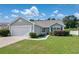 Inviting single-story home with green shutters, a well-kept lawn, and a two-car garage at 219 Blackpepper Loop, Little River, SC 29566
