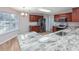Well-lit kitchen featuring granite countertops, stainless steel appliances, and wood cabinets at 219 Blackpepper Loop, Little River, SC 29566