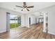 Bright living room with wood floors, open layout, and access to the backyard through sliding glass doors at 219 Blackpepper Loop, Little River, SC 29566
