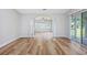 Bright and airy living room with wood floors, large windows, and access to the outdoors at 219 Blackpepper Loop, Little River, SC 29566