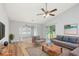 Cozy living room with vaulted ceilings, a ceiling fan, and sliding glass doors to the patio at 219 Blackpepper Loop, Little River, SC 29566