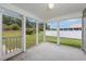A screened-in porch offers a serene view of the green lawn and backyard, enhancing outdoor living at 219 Blackpepper Loop, Little River, SC 29566