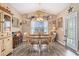 Bright dining room with a wood table, six chairs, and decoratively adorned shelf at 227 Palm Terrace Loop, Conway, SC 29526