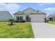 Charming single-story home with manicured lawn, attached two-car garage, and quaint curb appeal at 227 Palm Terrace Loop, Conway, SC 29526