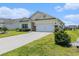 Charming one-story home featuring a manicured lawn and an attached two-car garage at 227 Palm Terrace Loop, Conway, SC 29526