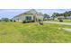 Lovely home featuring a beautiful lawn, palm trees, and colorful flower beds at 227 Palm Terrace Loop, Conway, SC 29526