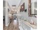 Neutral-toned hallway features wood floors, decorative mirror, and transitions to the living area at 227 Palm Terrace Loop, Conway, SC 29526