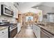 Bright kitchen showcasing white cabinets, granite counters, and a seamless view into the dining area at 227 Palm Terrace Loop, Conway, SC 29526