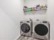 Laundry room featuring stainless steel washer and dryer with overhead shelf at 227 Palm Terrace Loop, Conway, SC 29526