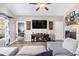 Bright living room with a modern electric fireplace, a large sectional sofa, and views to the bedroom at 227 Palm Terrace Loop, Conway, SC 29526