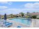 Community pool with lounge chairs and families swimming on a sunny day at 227 Palm Terrace Loop, Conway, SC 29526
