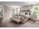 Spacious main bedroom features neutral tones, large windows, and stylish furnishings at 2273 Hazel Way, Longs, SC 29568