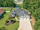 Stunning aerial view of a home with a three car garage, landscaped yard, and a pond at 229 Duchess Ct., Myrtle Beach, SC 29588
