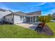 Well-manicured backyard with screened in porch and a small palm tree at 229 Duchess Ct., Myrtle Beach, SC 29588