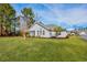 Beautifully landscaped backyard with a screened-in porch and lush green lawn at 229 Duchess Ct., Myrtle Beach, SC 29588