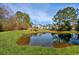 A grassy backyard with a pond that provides serene water view at 229 Duchess Ct., Myrtle Beach, SC 29588