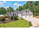 Beautifully landscaped front yard featuring a three-car garage and mature palm trees at 229 Duchess Ct., Myrtle Beach, SC 29588
