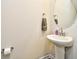 Clean pedestal sink in the bathroom with a large round mirror and a towel rack at 2325 Copper Creek Loop, Longs, SC 29568