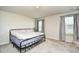 Simple bedroom featuring a metal frame bed, neutral walls, and two windows with blinds at 2325 Copper Creek Loop, Longs, SC 29568