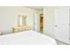 Bright bedroom with white dresser and mirror and an open bathroom door at 2325 Copper Creek Loop, Longs, SC 29568