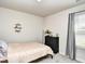 Neutral bedroom featuring a light pink bedspread, dresser, and window at 2325 Copper Creek Loop, Longs, SC 29568