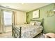 Inviting bedroom with green accent wall, comfortable bed, and natural light at 2325 Copper Creek Loop, Longs, SC 29568