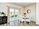Cozy dining area with sliding door access to the backyard, featuring a table and chairs in a naturally lit space at 2325 Copper Creek Loop, Longs, SC 29568