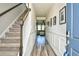 Welcoming entryway with hardwood floors, staircase, and stylish decor at 2325 Copper Creek Loop, Longs, SC 29568