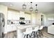 Bright kitchen featuring white cabinets, granite countertops, stainless steel appliances and a center island with barstool seating at 2325 Copper Creek Loop, Longs, SC 29568