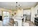 An open kitchen layout with stainless steel appliances, granite countertops, and a view into the dining area at 2325 Copper Creek Loop, Longs, SC 29568