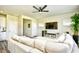 Bright living room with hardwood floors, a large sectional sofa, and ample windows at 2325 Copper Creek Loop, Longs, SC 29568