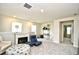 Spacious living area with a fireplace, large windows, and comfortable seating arrangements at 2325 Copper Creek Loop, Longs, SC 29568