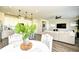 Bright, open-concept living space connects dining area, kitchen, and features a large sectional at 2325 Copper Creek Loop, Longs, SC 29568